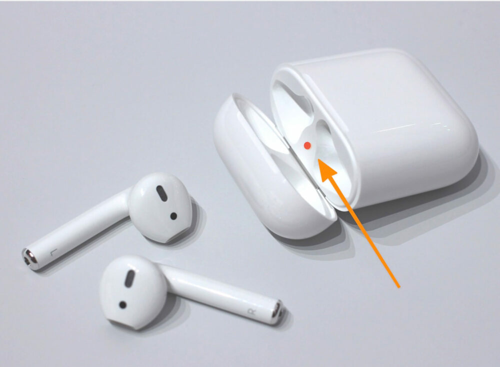 Put both AirPods in the charging case
Press and hold the button on the back of the case until the light flashes amber