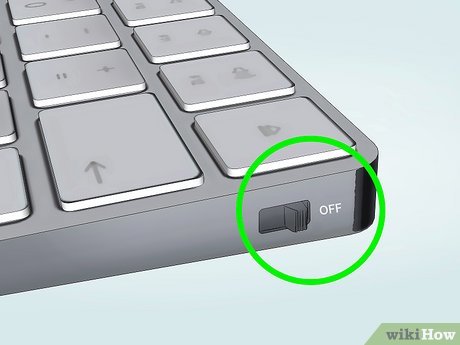 Turn off the keyboard and unplug it from the computer.
Locate the small reset button on the back or underside of the keyboard.